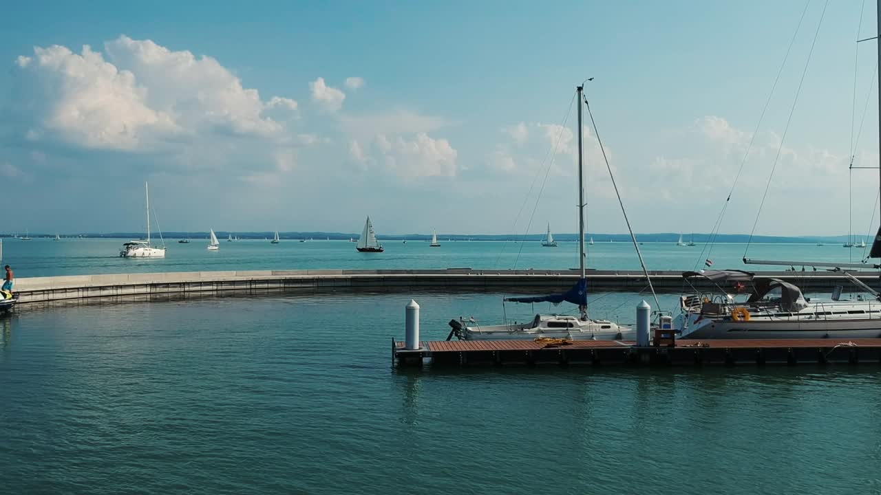 Drone footage of Balaton dockyard and its little bay, beautiful green water and ships everywhere.