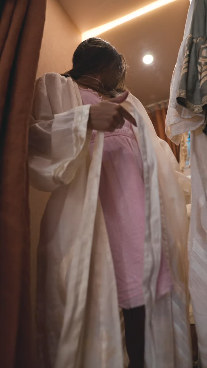 Women in Fitting Room Trying on Clothes