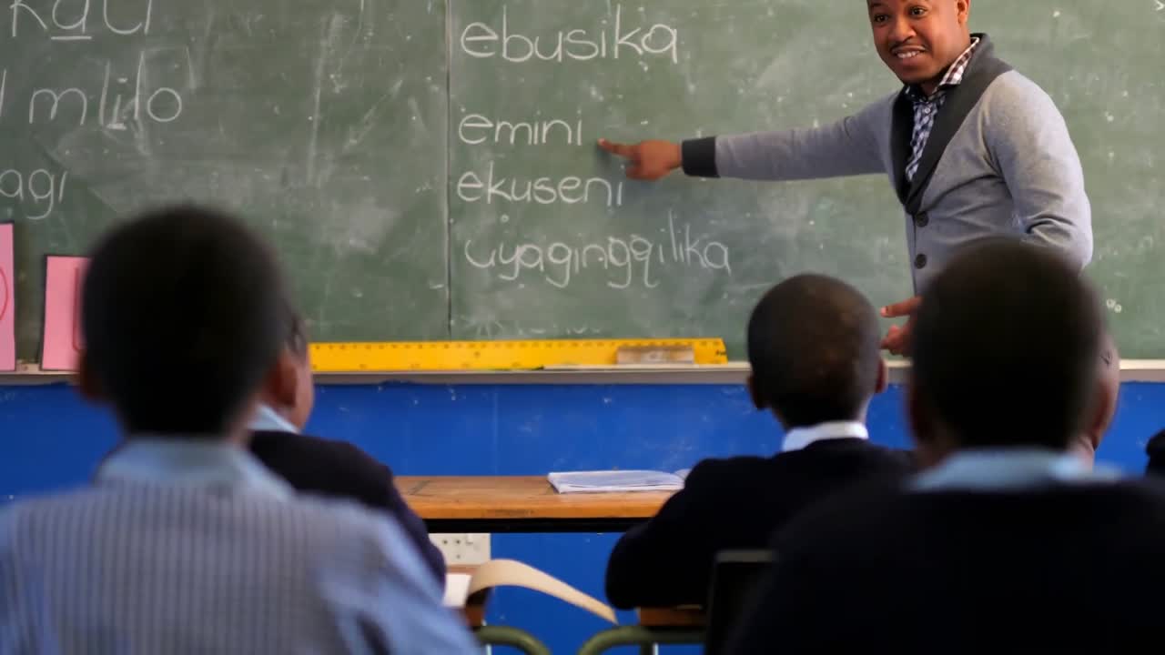 Male teacher teaching students in the class 4k