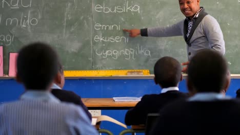 male teacher teaching students in the class 4k