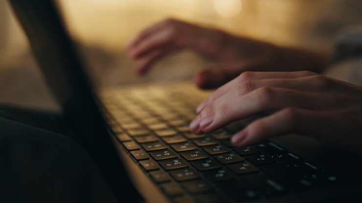 Hands typing keyboard night closeup. Late manager freelancer working computer