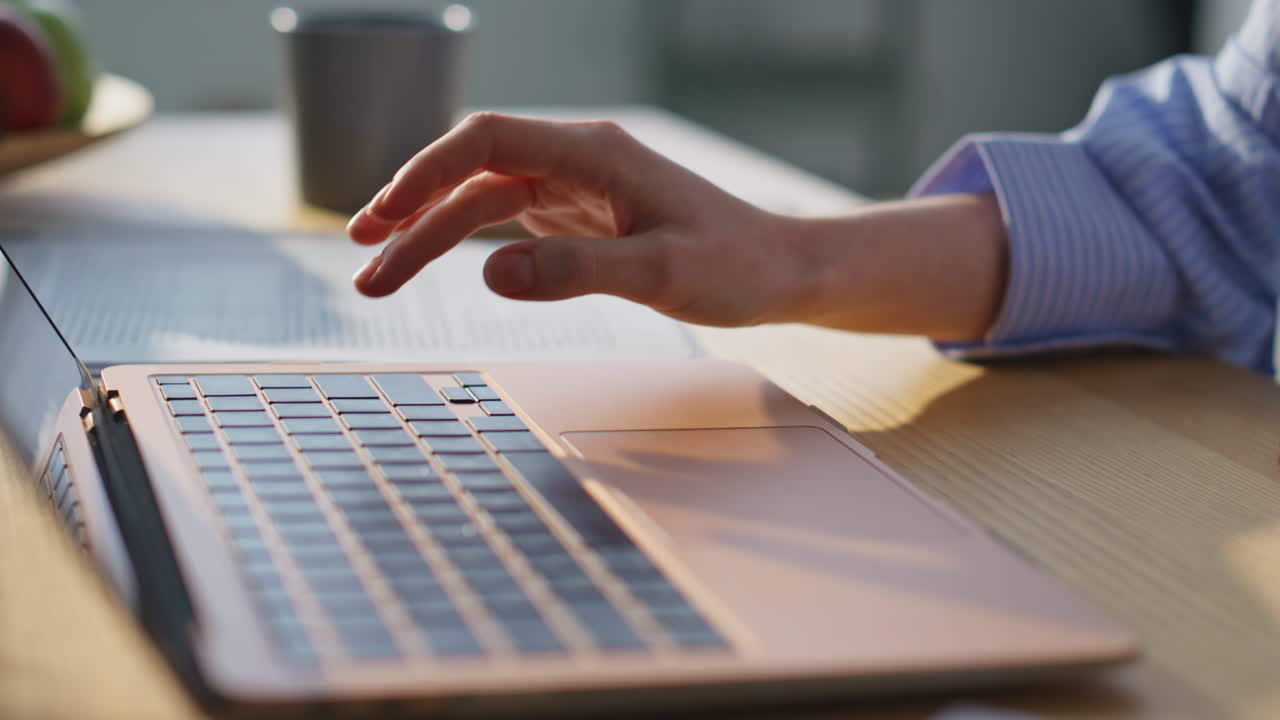 Unknown businesswoman pressing laptop key browsing internet at office closeup