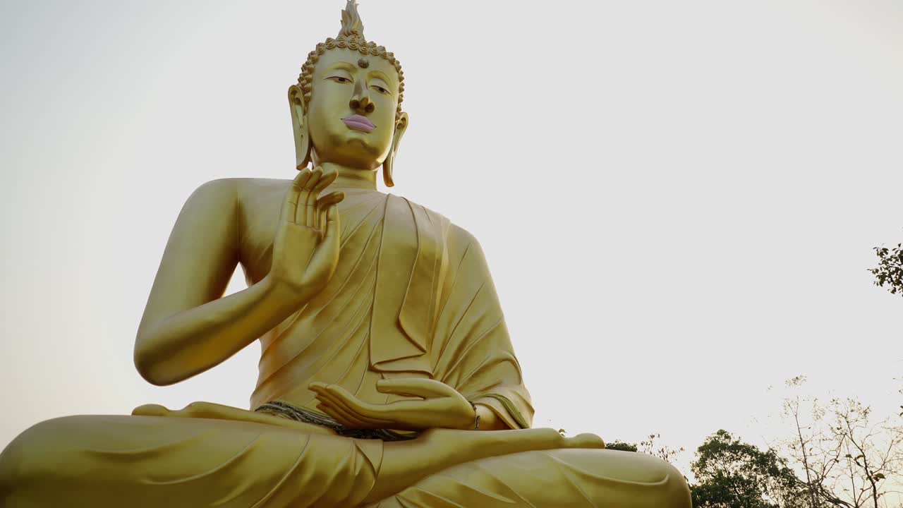 Majestic Golden Buddha Statue Against a Serene Sky