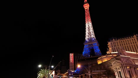 las vegas nevada usa, paris hotel - casino and illuminated eiffel tower replica in french flag colors. tilt up