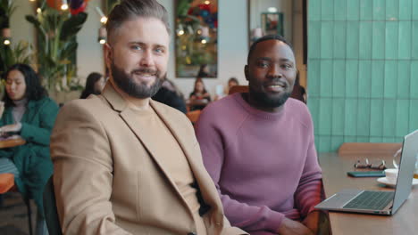 portrait of two multiethnic businessmen in cafe