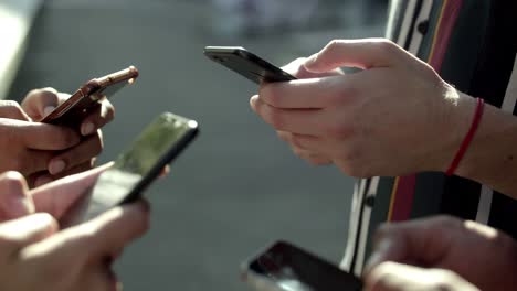 closeup view of young people using smartphones.