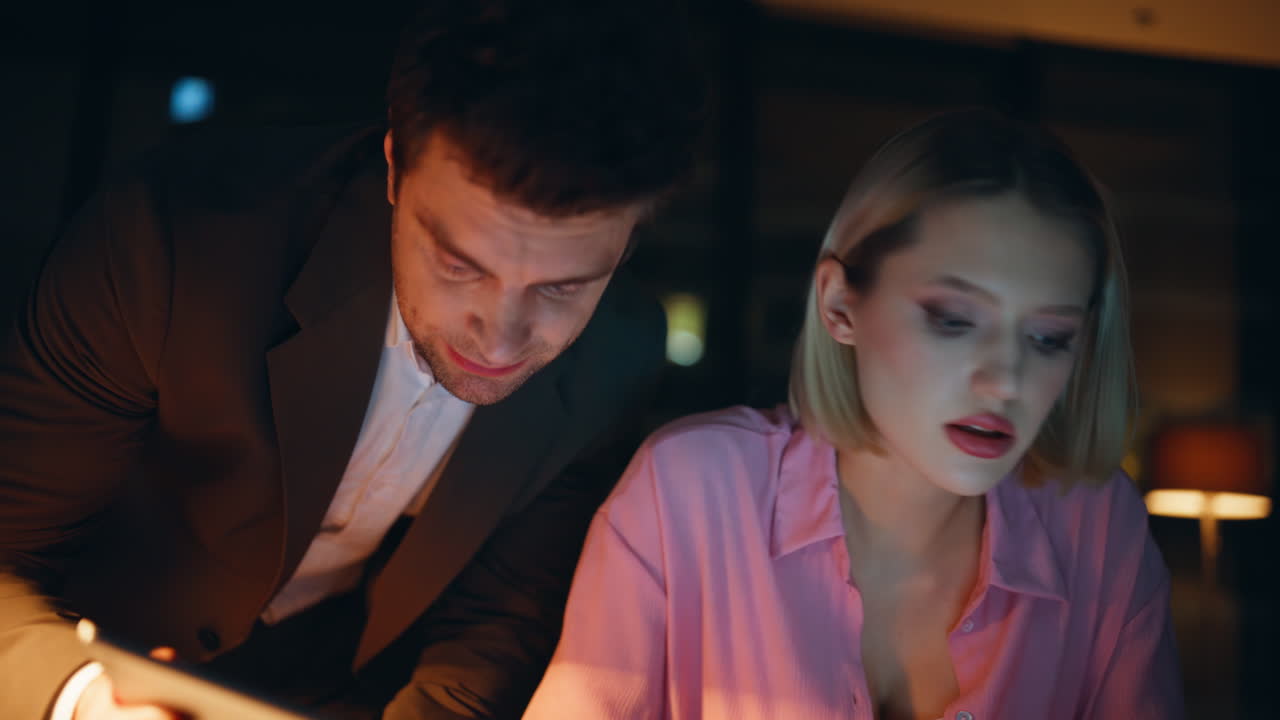 Two colleagues working late at night