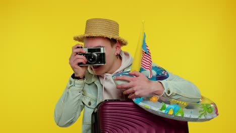 man tourist photographer taking photos on retro camera and smiling, travel, summer holiday vacation