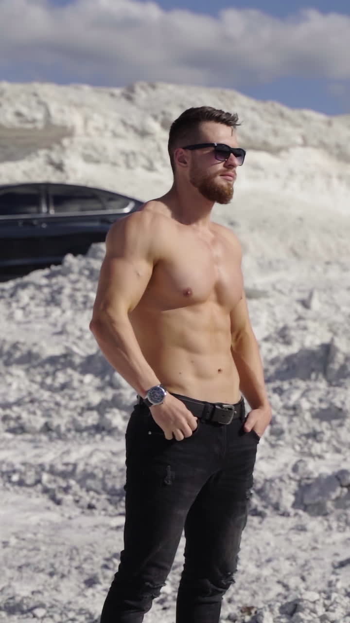 Man with muscular naked torso. Young bearded man in cap with perfect body