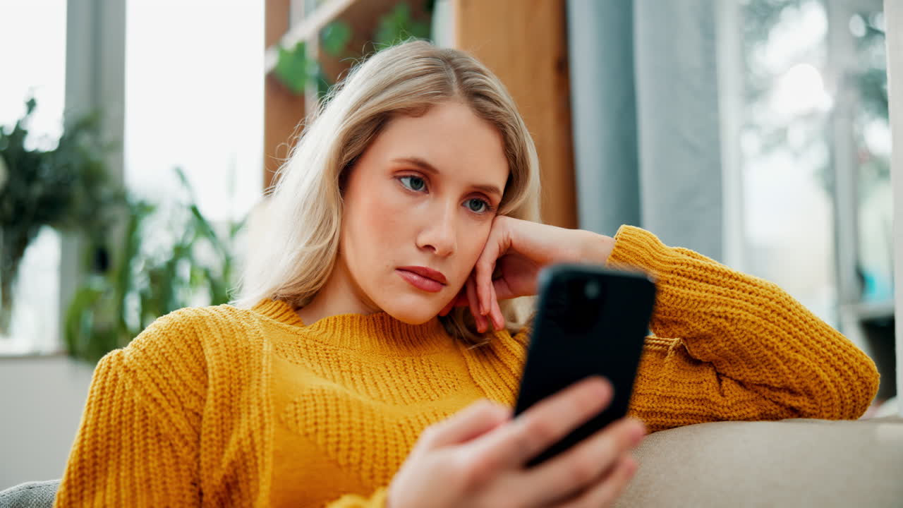 Sad woman looking at smartphone