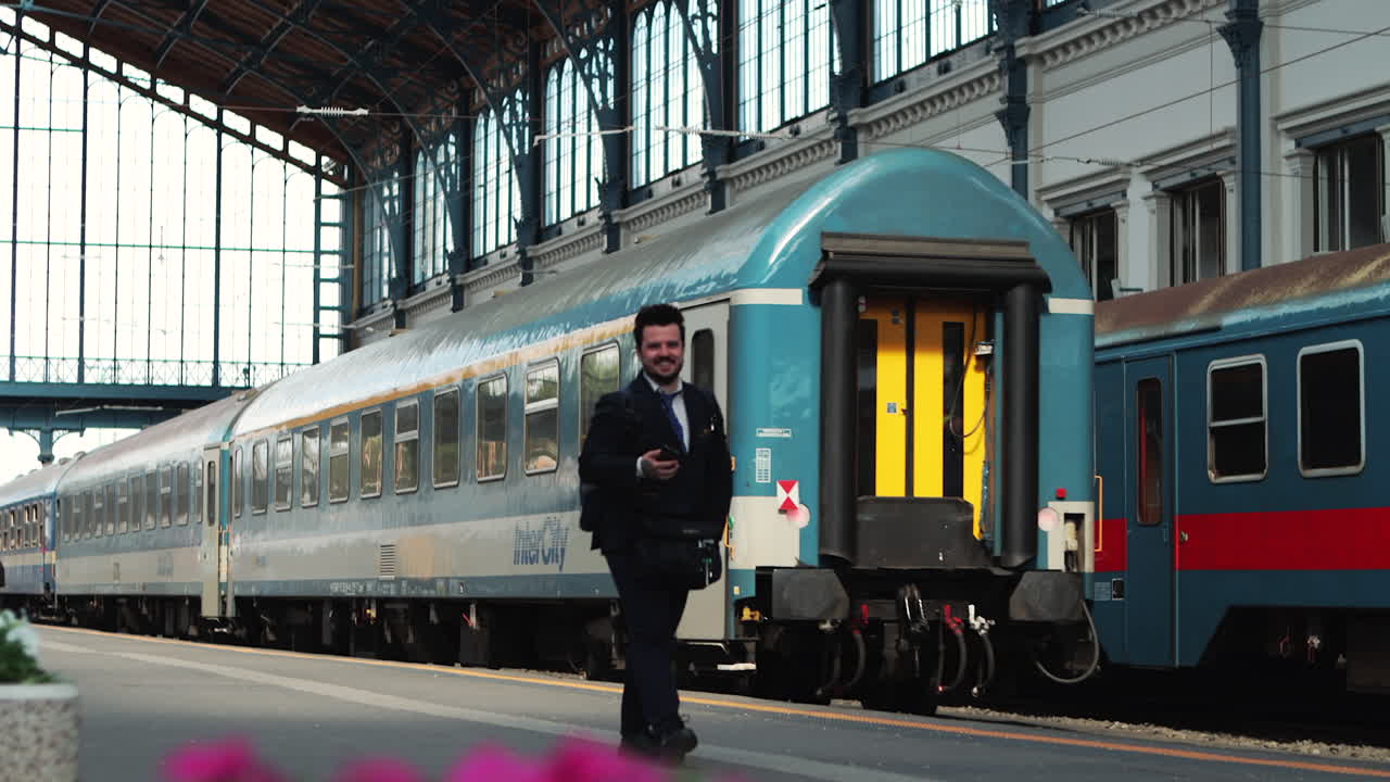 Man watches as train departs from Nyugati Station, turns and walks away