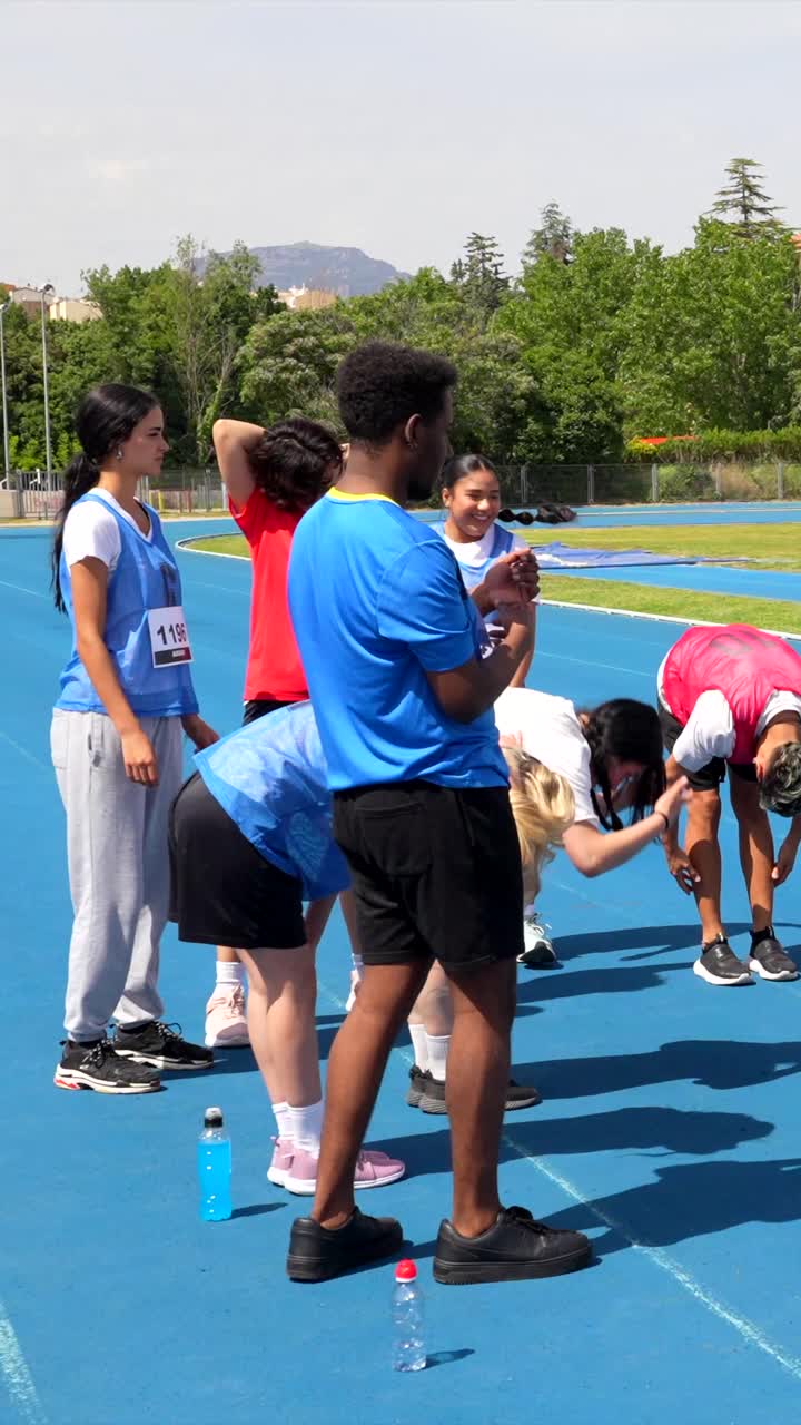 Athletes stretching and warming up on a track