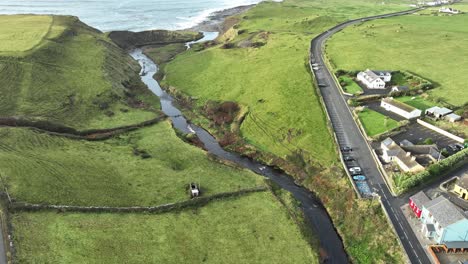 drone static of doolin village with river leading to the atlantic sea wild atlantic way