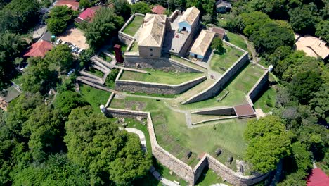 aerial drone top view of são josé da ponta grossa fortress of colonial architecture era brazil empire in praia do forte and jurere internacional, florianópolis, santa catarina
