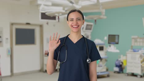 happy indian female doctor waving hi