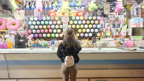 Woman Playing a Carnival Game at Night