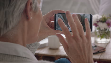 mature-woman-having-video-chat-using-smartphone-grandmother-waving-at-baby-enjoying-chatting-to-grandchild-on-mobile-phone-screen-4k-footage