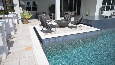 new construction beautiful dream pool and spa showcasing decking area with water features and built in pool lounge