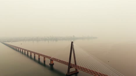 drone view of border bridge on the paraná river with sky polluted by forest fire smoke