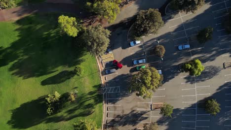 Red-car-parked-in-parking-lot-Perth-suburb,-Western-Australia