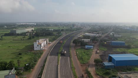 highway running through vast fields and farmlands on a clear summer day.