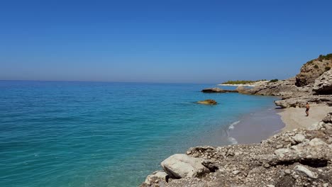 dreamy beach with untouched sand and cliffs washed by blue sea, paradise summer vacation in mediterranean, albania