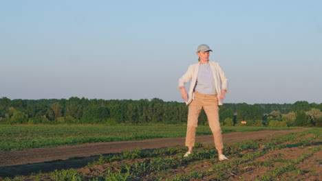 woman dancing in a field at sunset