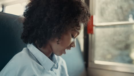 girl look down talking with friend sitting bus closeup. pupil sit at window.