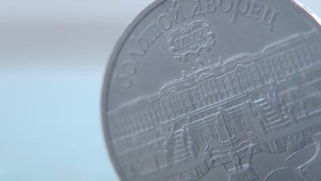 hyper macro shot of an old metal russian 5 ruble coin, cccp sssr symbol, back side, vintage money, slow cinematic 4k video pan left