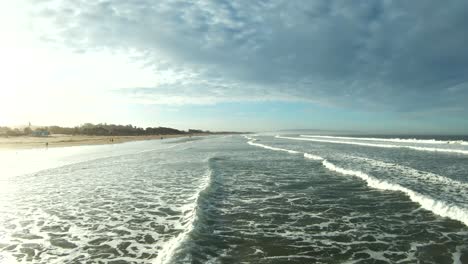 High-speed-flight-over-breaking-waves-just-above-the-surface-of-the-ocean---wide-angle-immersive-view