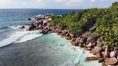 Aerial-view-of-the-white-beaches-and-turquoise-waters-at-Anse-Coco,-Petit-Anse-and-Grand-Anse-on-La-Digue,-an-island-of-the-Seychelles