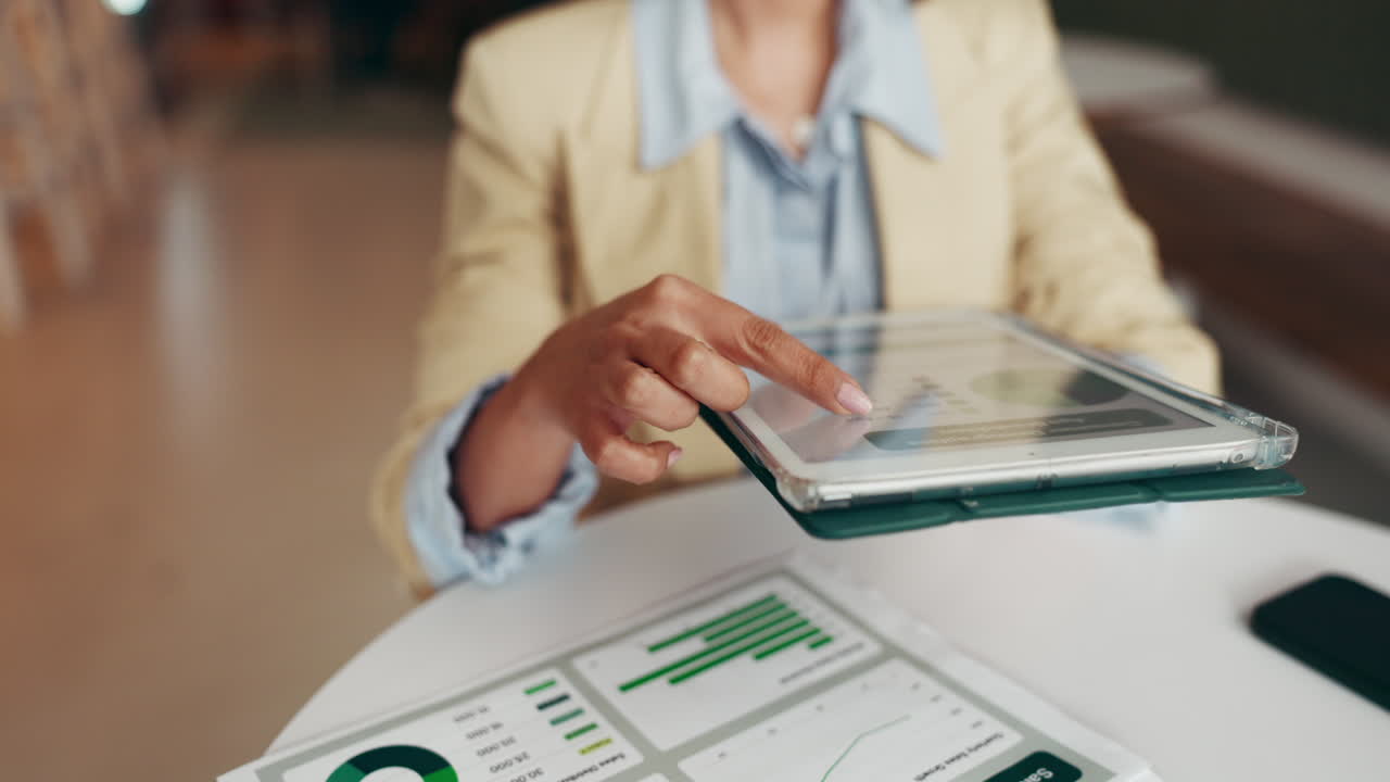 Businesswoman Analyzing Data on Tablet
