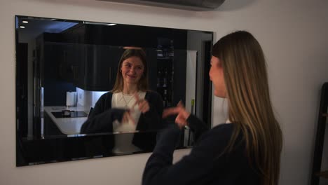 female model looking at herself, reflection and sorting out her hair in a mirror with cringe worthy reaction at end