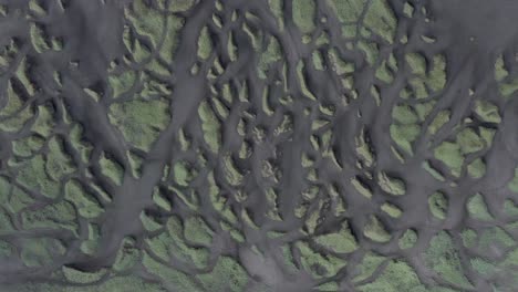 Top-down-aerial-of-famous-Sandvik-beach-with-grass-dunes-and-black-volcanic-sand