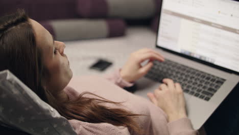 business woman browsing data report on laptop computer screen online at home