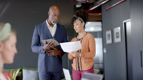 Diverse-business-people-discussing-in-office-with-copy-space