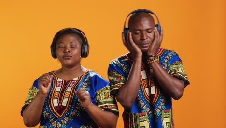 happy ethnic couple listening to favorite song on headset