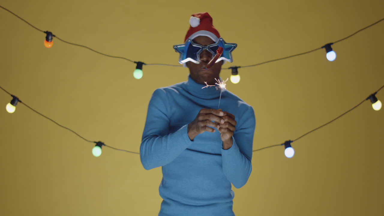 Man Celebrating Holiday Season with Sparkler and Festive Attire