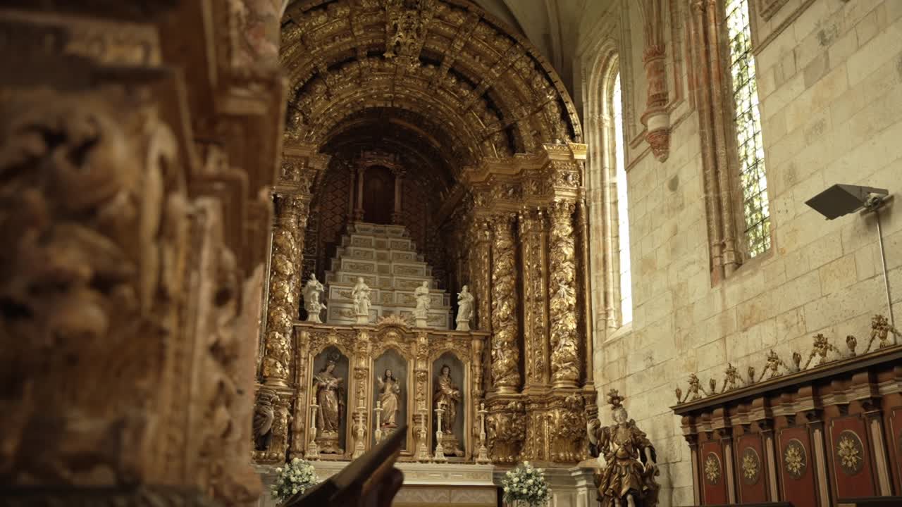 ornate golden baroque altar with statues and stairway in a richly decorated church interior