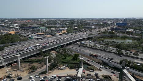 aerial view of a busy urban highway intersection with traffic and construction