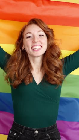 happy woman holding a rainbow pride flag