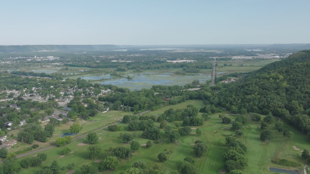 Aerial View of a Golf Course near a River and Town