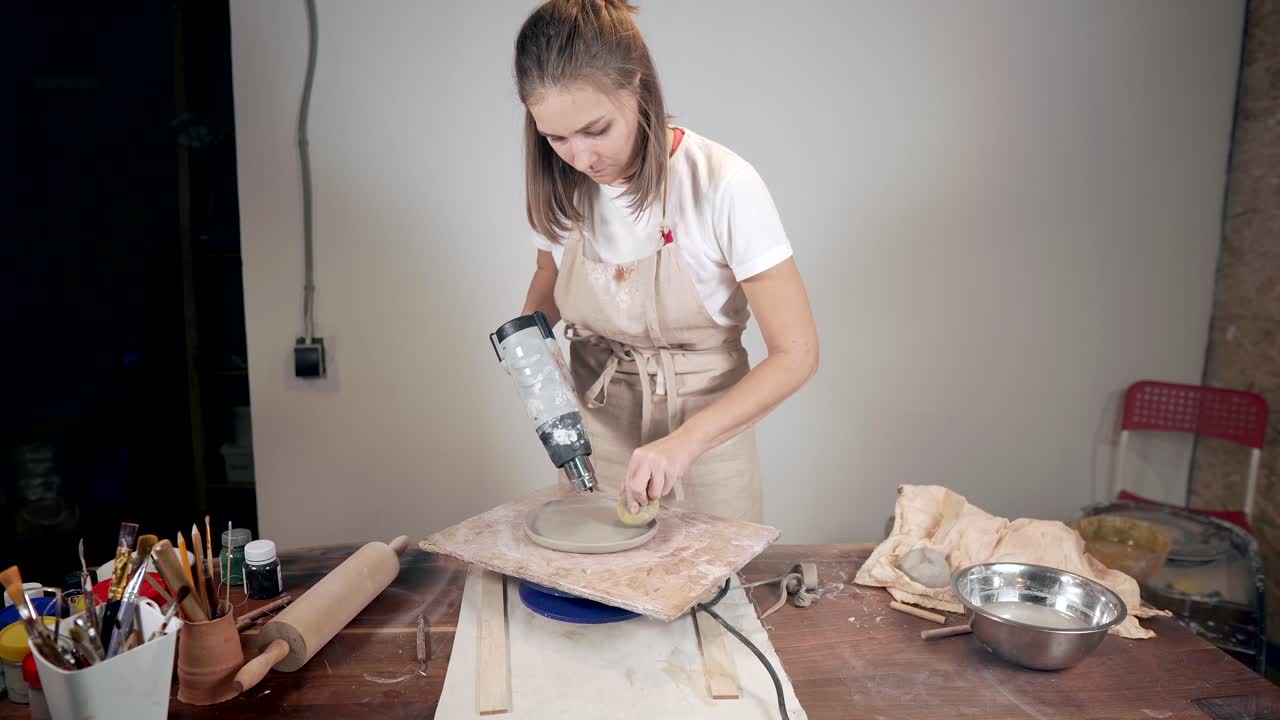Woman Pottery Artist Working on a Piece