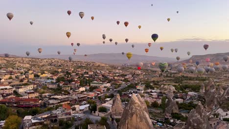 cappadocia live view today hot air balloon fly now at twilight early morning before sunrise after sunset when the city lights on fire aircraft wide landscape view rock mountain house turkey istanbul