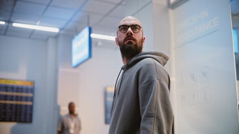 man waiting in airport terminal