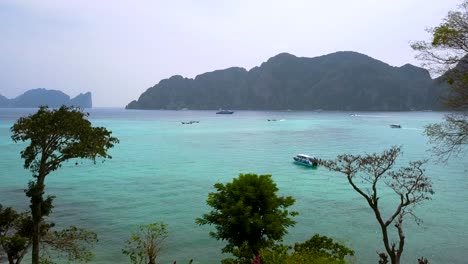 4K-AERIAL-FORWARD-VIEW-from-hotel,-between-trees-towards-the-sea-in-Phi-Phi-Don