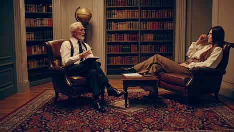 psychologist meeting with patient in a library