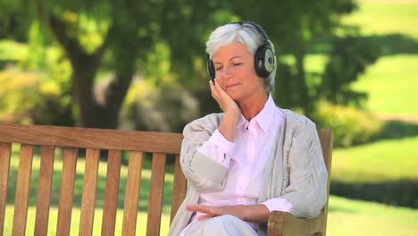 mature woman listening to music outside