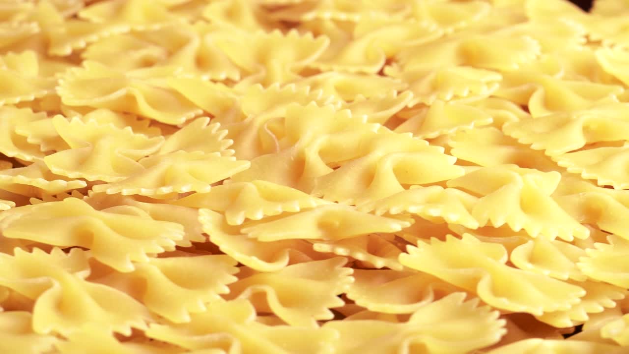 Pile of raw italian farfalle pasta in motion