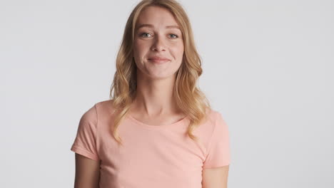 Caucasian-woman-waving-hello-on-camera.